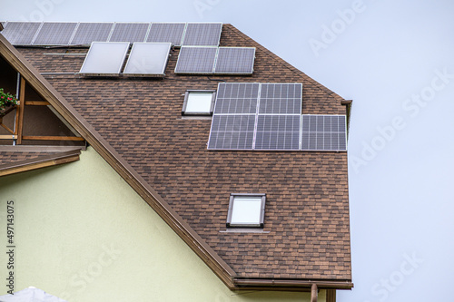 Solar panels on the roof of a private house. Ecological sources of energy.
