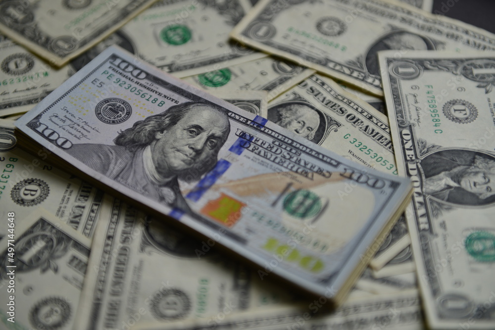 Currency war concept, Global economic crisis situation. A heap of one hundred dollar bills on The US currency notes. Shallow depth of field. Selective focus. Currency war concept, Global economic crisis situation. A heap of one hundred dollar bills on The US currency notes. Shallow depth of field. Selective focus.