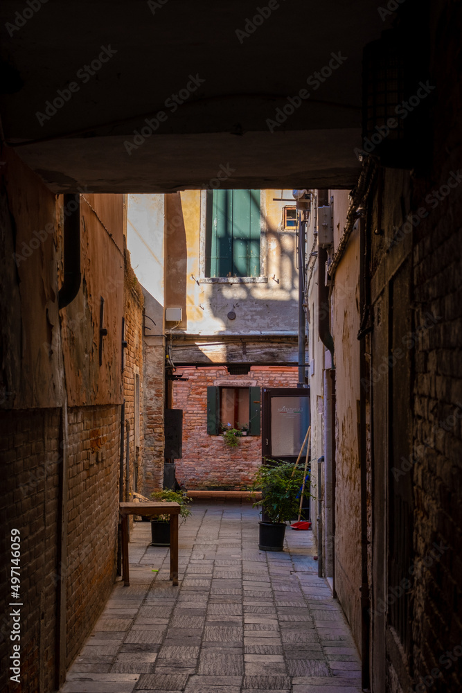 Venice canal house window seen through the alley