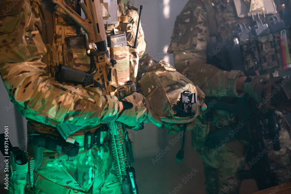 Cropped image of brave men in military equipment. Men in uniforms holding machine gun. Military, army, airsoft concept