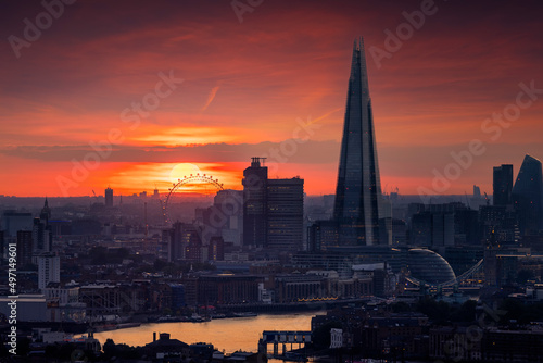 Elevated view of the modern skyline of London, United Kingdom, with many popular tourist attractions during a fiery sunset
