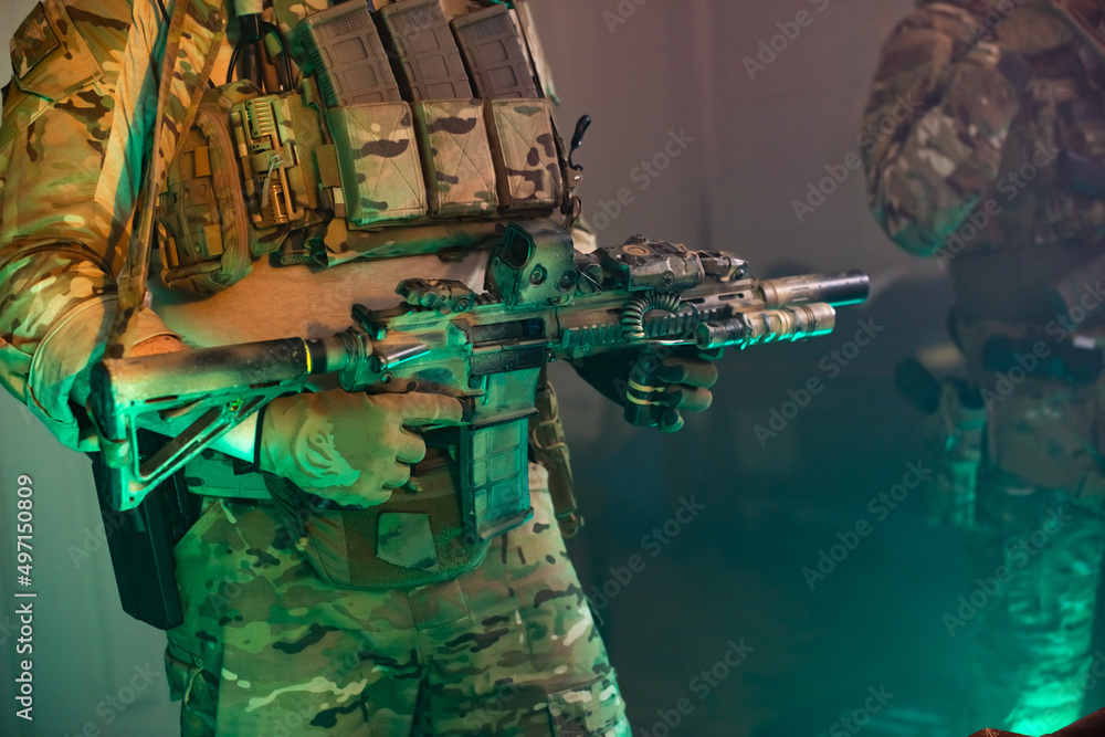 Fototapeta premium Cropped image of man in military equipment with gun. Male hands in gloves holding weapon. Military, army, airsoft concept