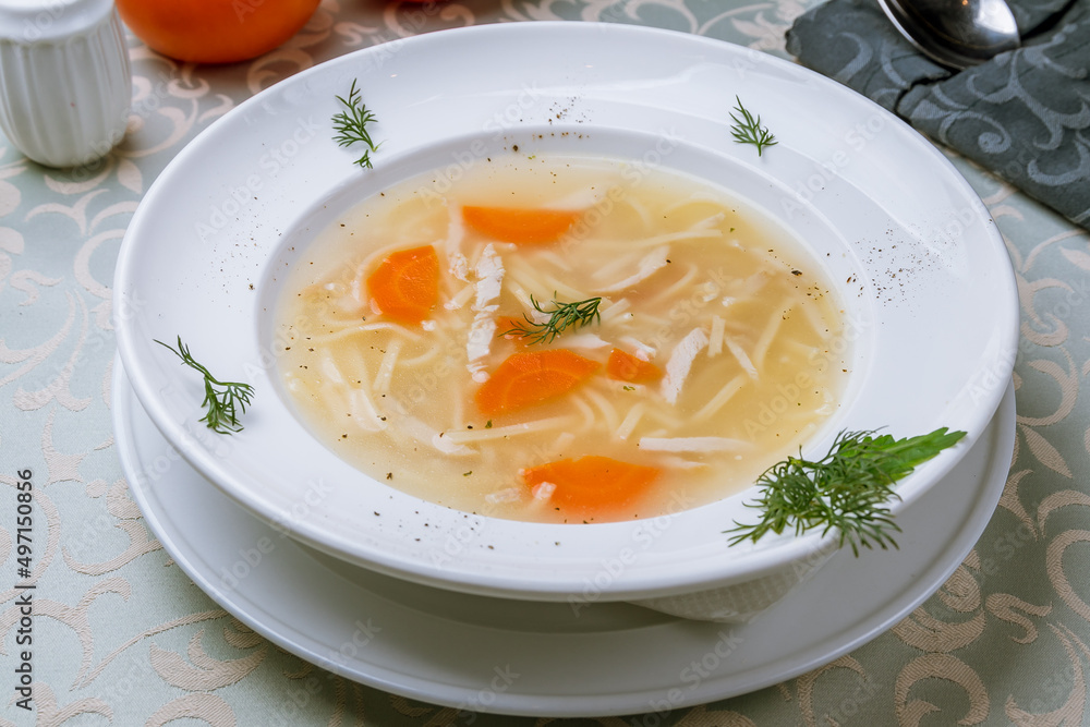 Chicken soup bouillon in a plate Chicken soup bouillon in a plate