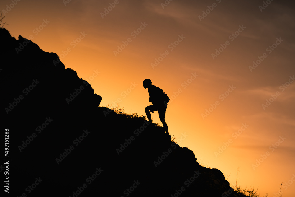 Goal setting. Silhouette of man climbing up mountain
