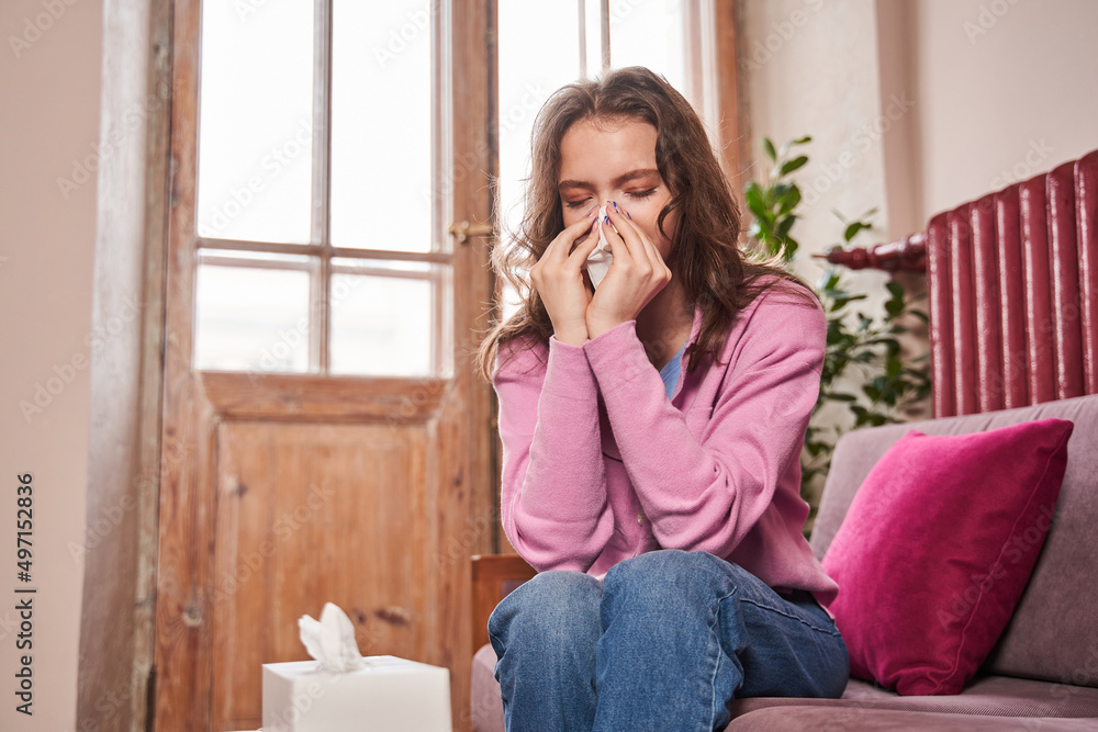 Upset caucasian teen child girl holding napkin and crying while sitting at the therapy Upset caucasian teen child girl holding napkin and crying while sitting at the therapy