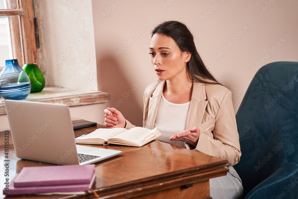Female psychotherapist gesturing while telling her opinion to patient during the therapy Female psychotherapist gesturing while telling her opinion to patient during the therapy