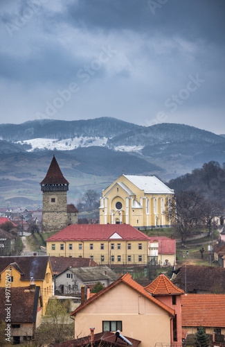 Romania, Dumitra, Evangelical Church, today the Orthodox Church “St. Apostle Peter and Paul ”and Bacon Tower, April 2022, panoramic view from the cemetery”,