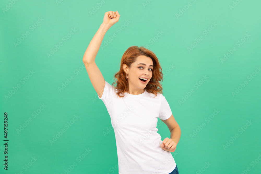 happy redhead woman with curly hair dancing having fun on blue background, have fun happy redhead woman with curly hair dancing having fun on blue background, have fun