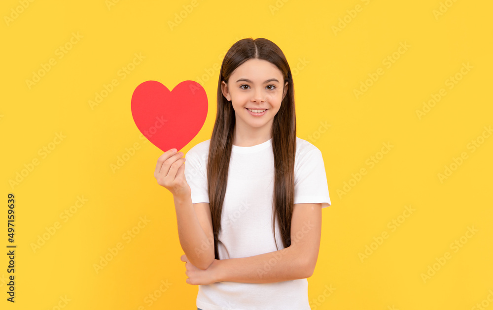 cheerful child with red heart on yellow background, love day cheerful child with red heart on yellow background, love day