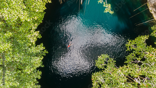 Female Tourist Swim in Open Cenote. Aerial View