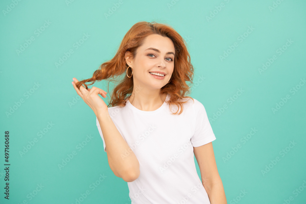 glad redhead girl with curly hair on blue background glad redhead girl with curly hair on blue background