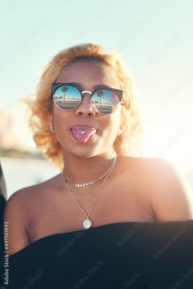 Having fun will add happiness to your life. Portrait of a beautiful young woman at the beach.