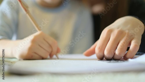 Woman teach son how to do homework at home,school child family education