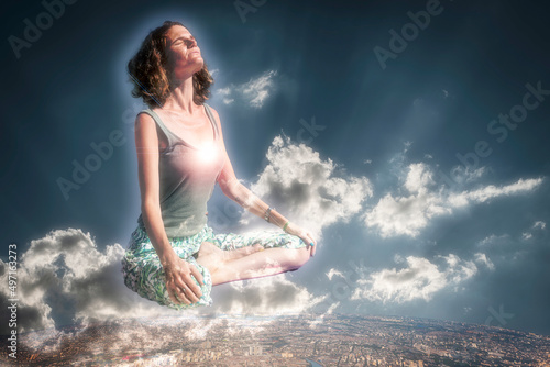 Composite of young woman on a yoga relax position among clouds © Patricio