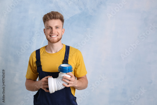 Handsome young plumber on c...