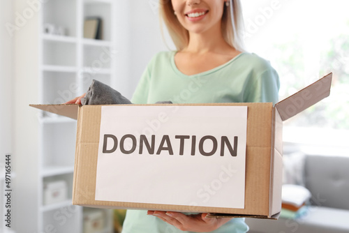 Young woman holding box wit...