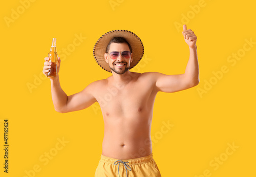 Handsome man with beer show...