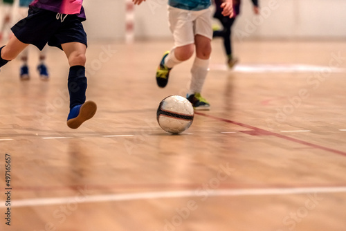 a children futsal player prepares to shoot at goal photo