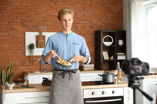 Young man cooking tasty ric...