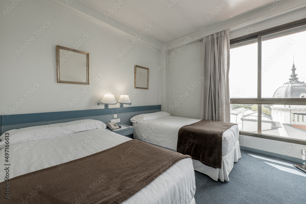 Bedroom with double beds, pale blue accents, color-matched carpet, good view out the window Bedroom with double beds, pale blue accents, color-matched carpet, good view out the window