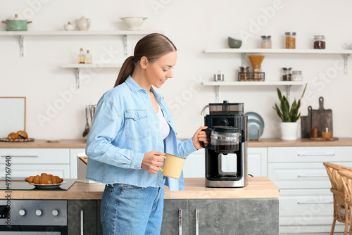 Young woman with cup and co...