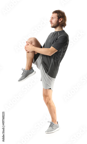 Sporty man stretching on wh...