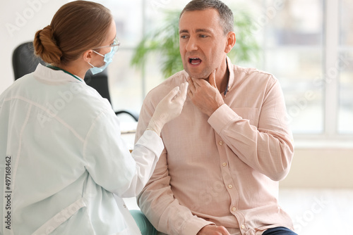 Doctor examining man with s...