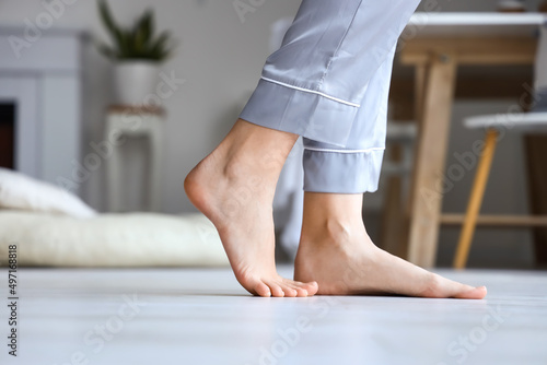 Barefoot woman in pajamas at home, closeup © Pixel-Shot