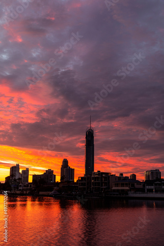 Orange sunrise clouds over Gold Coast city scape silhouette