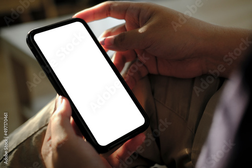 Mockup image of woman hands holding smartphone with blank screen for advertise text.