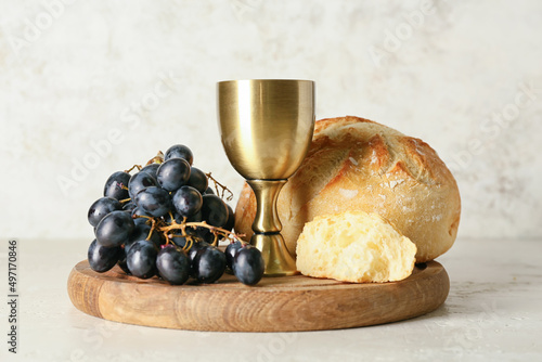 Photography Cup of wine with grapes and bread on light background