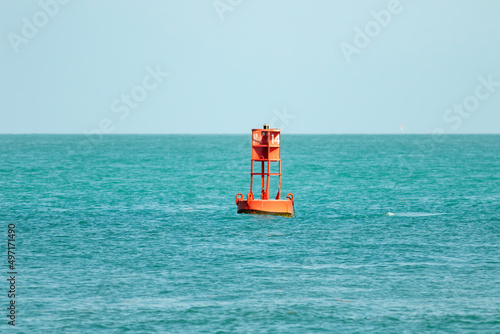 A channel buoy bobs in the ocean current  