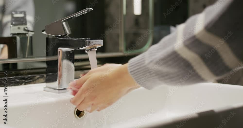 Woman wash her hand in toilet Woman wash her hand in toilet