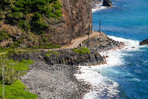 Aerial view of a narrow passage on Hana Highway in the southeast of Maui island, Hawaii - Winding coastal dirt road along a wild coast of the Pacific Ocean photo