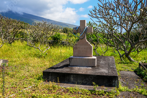 Christian grave in the cemetery of Saint Joseph Church, built in 1862 along the Piilani Highway in the south of Maui island in Hawaii - Religious building on the slopes of the Haleakala volcano photo