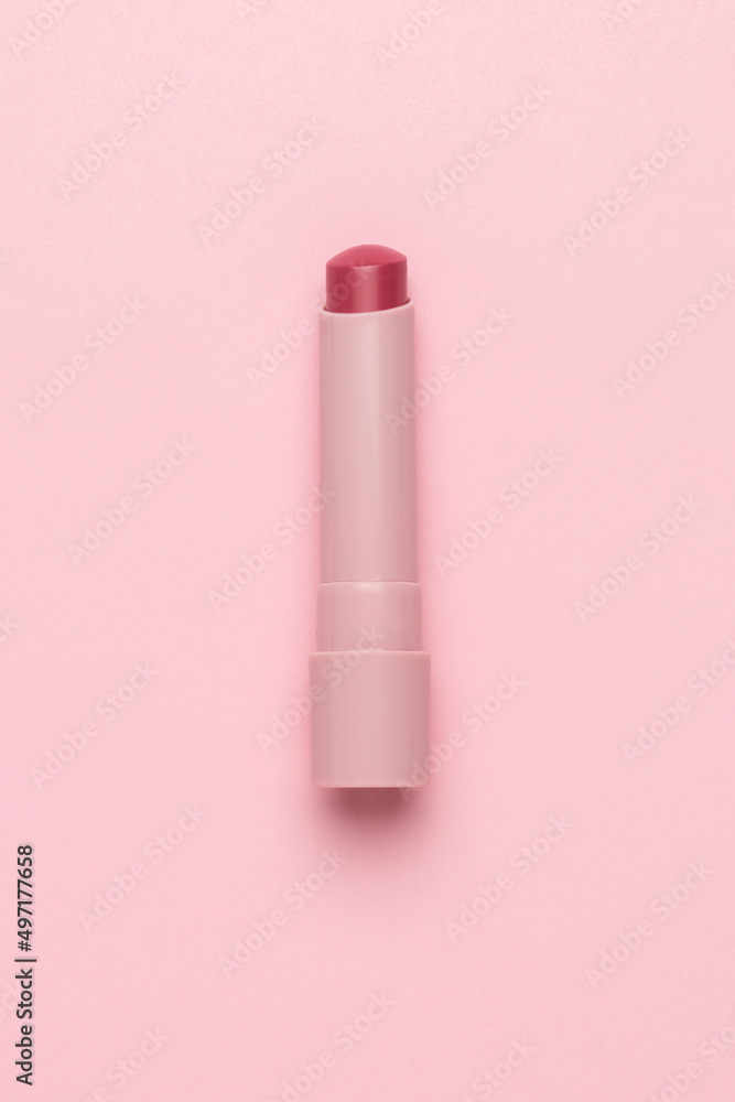 Red lipstick in a pink tube on a pink background. Flat lay. Red lipstick in a pink tube on a pink background. Flat lay.