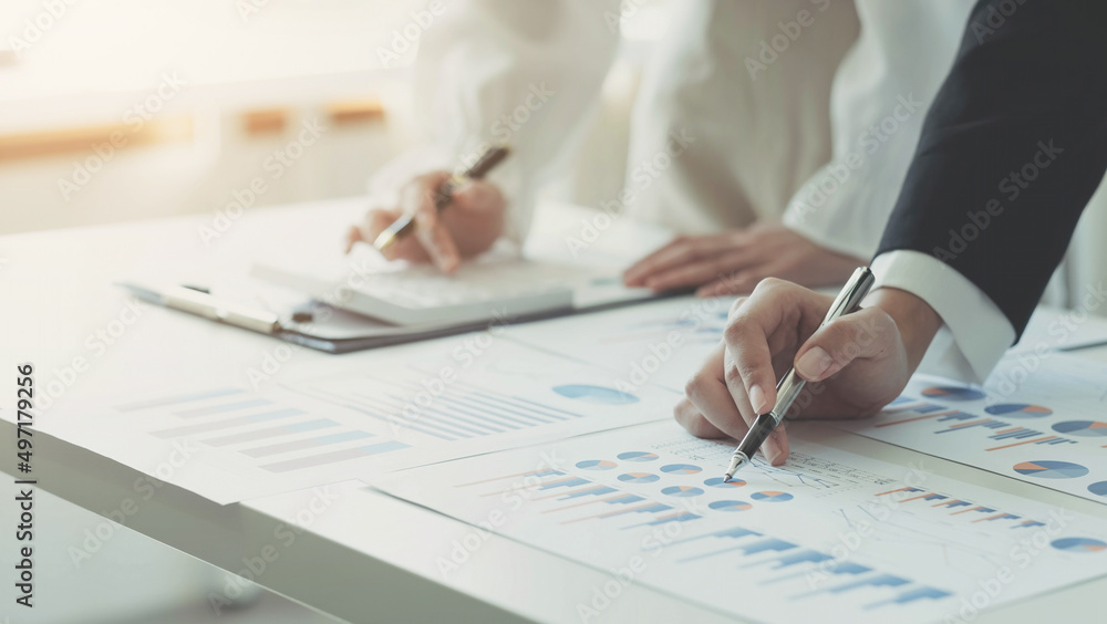 Close up team businesswoman analysis on data paper with business woman using calculator at the office Close up team businesswoman analysis on data paper with business woman using calculator at the office