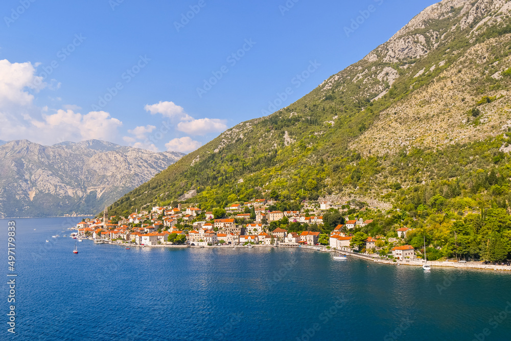 View of the the medieval village of Perast, including the St. Nikola Church tower, along the coast of the Bay of Kotor, Montenegro.
