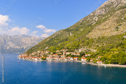 View of the the medieval village of Perast, including the St. Nikola Church tower, along the coast of the Bay of Kotor, Montenegro. 