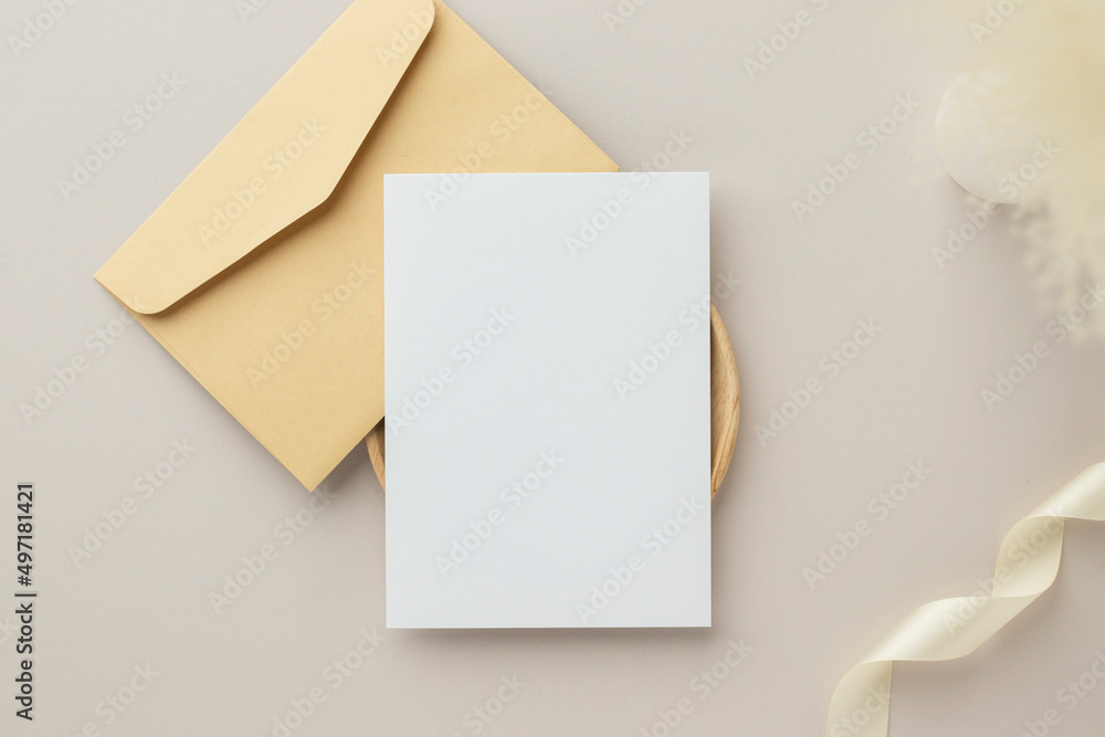 Blank greeting card invitation Mockup 5x7 on envelope with dry flowers and ribbon on paper background, flat lay, mockup Blank greeting card invitation Mockup 5x7 on envelope with dry flowers and ribbon on paper background, flat lay, mockup
