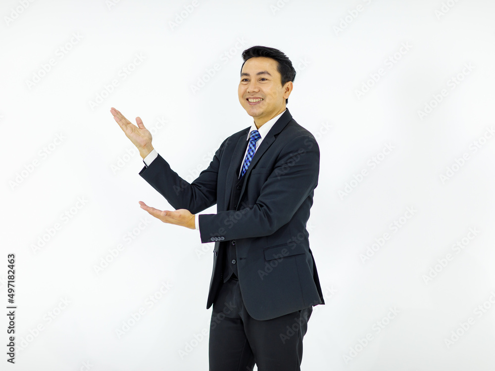 Studio isolated cutout shot of Asian young happy male businessman in formal business suit standing smiling holding hands showing presenting advertising product on empty copy space on white background Studio isolated cutout shot of Asian young happy male businessman in formal business suit standing smiling holding hands showing presenting advertising product on empty copy space on white background