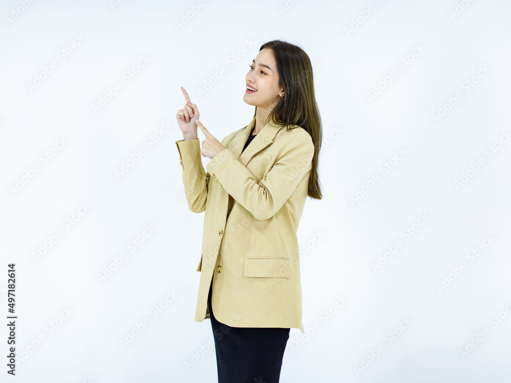 Studio isolated cutout full body shot of Asian young happy female businesswoman in stylish formal business suit standing smiling holding hands pointing looking advertising product on white background Studio isolated cutout full body shot of Asian young happy female businesswoman in stylish formal business suit standing smiling holding hands pointing looking advertising product on white background