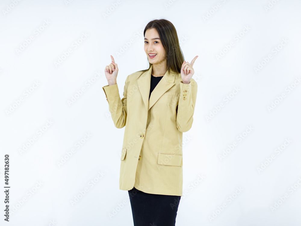 Studio isolated cutout full body shot of Asian young happy female businesswoman in stylish formal business suit standing smiling holding hands pointing looking advertising product on white background