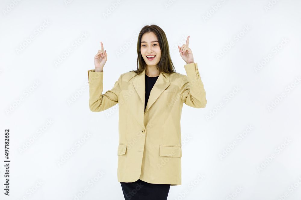 Studio isolated cutout full body shot of Asian young happy female businesswoman in stylish formal business suit standing smiling holding hands pointing looking advertising product on white background Studio isolated cutout full body shot of Asian young happy female businesswoman in stylish formal business suit standing smiling holding hands pointing looking advertising product on white background