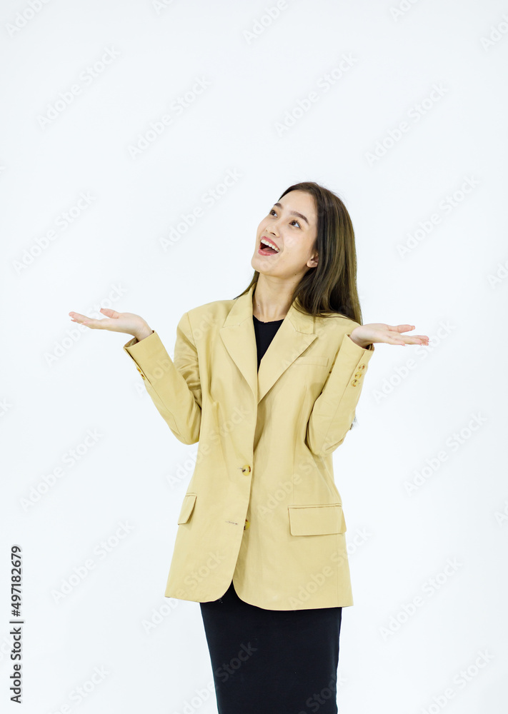 Studio isolated cutout full body shot of Asian young happy female businesswoman in stylish formal business suit standing smiling holding hands pointing looking advertising product on white background Studio isolated cutout full body shot of Asian young happy female businesswoman in stylish formal business suit standing smiling holding hands pointing looking advertising product on white background