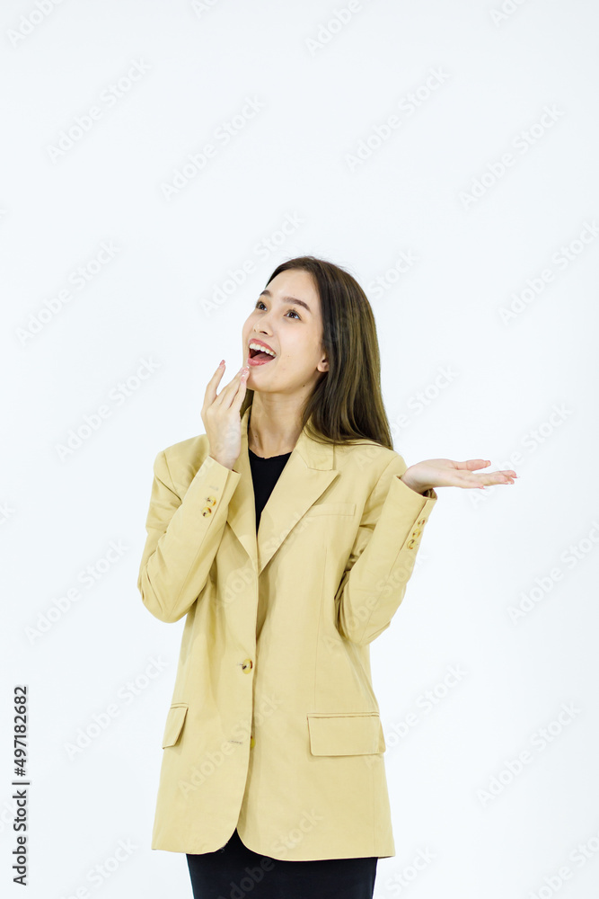 Studio isolated cutout full body shot of Asian young happy female businesswoman in stylish formal business suit standing smiling holding hands pointing looking advertising product on white background Studio isolated cutout full body shot of Asian young happy female businesswoman in stylish formal business suit standing smiling holding hands pointing looking advertising product on white background