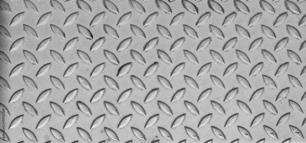 Industrial anti slip embossed stainless steel plate with diagonal bumps. Anti-slip surface. Background. Texture. Industrial anti slip embossed stainless steel plate with diagonal bumps. Anti-slip surface. Background. Texture.