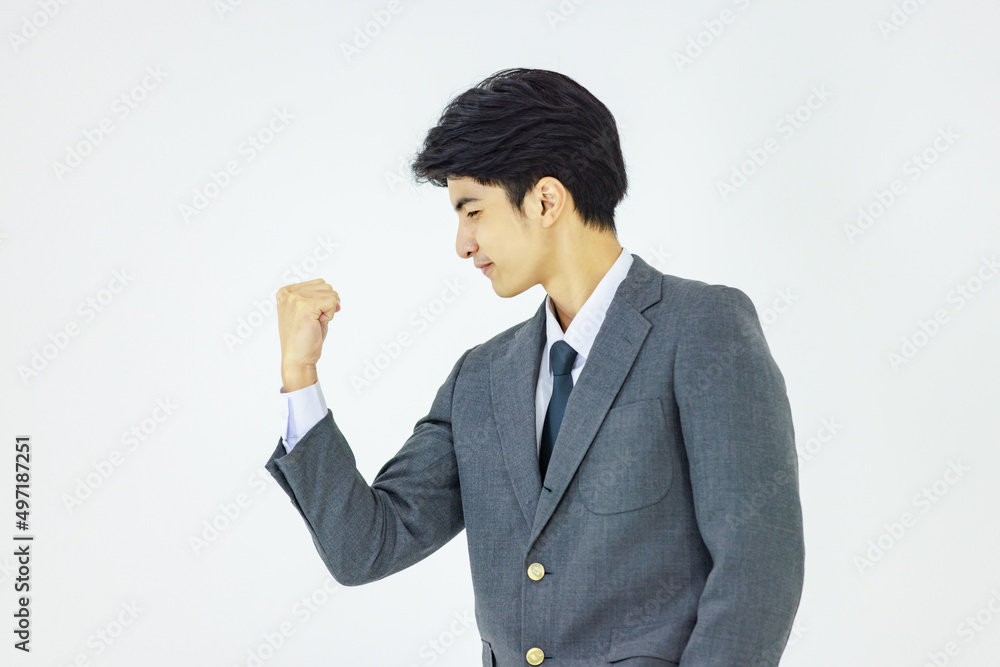 Closeup shot of Asian happy professional successful male businessman employee in formal business suit standing shouting holding fists up celebrating achievement important job done on white background Closeup shot of Asian happy professional successful male businessman employee in formal business suit standing shouting holding fists up celebrating achievement important job done on white background