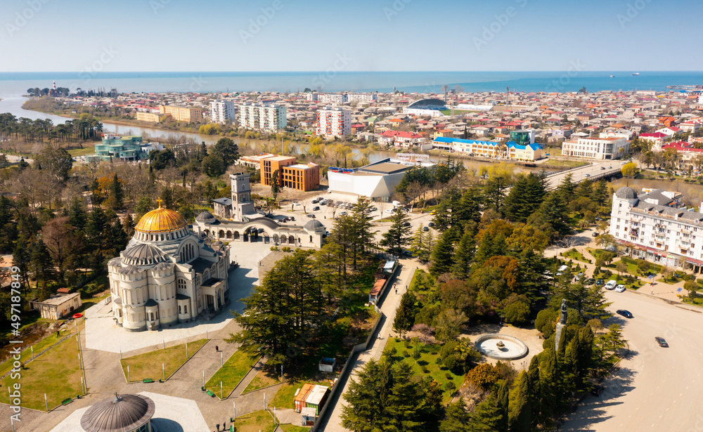 View from drone of modern landscape of Georgian port city of Poti overlooking residential areas and Orthodox Cathedral in Neo-Byzantine style on sunny spring day, Samegrelo-Zemo Svaneti region
