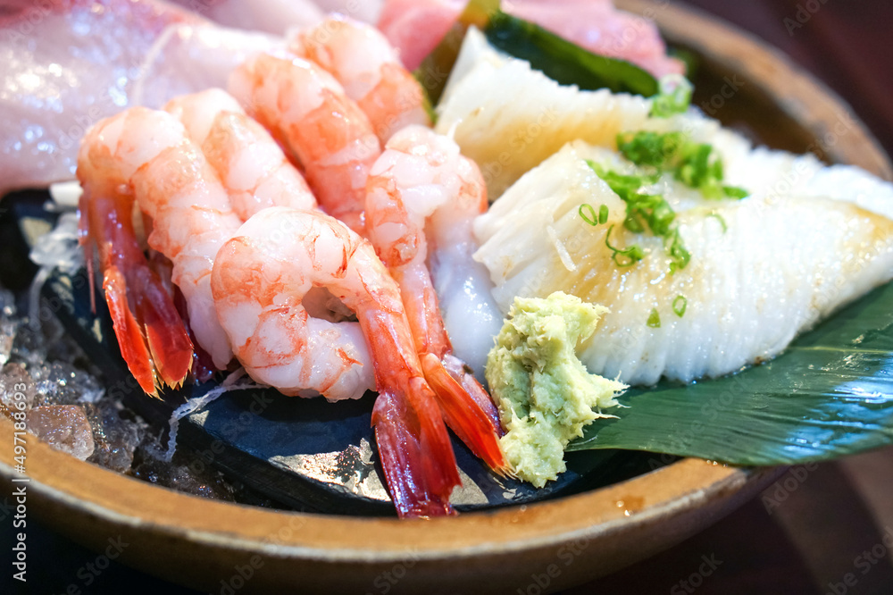 The sashimi set is beautifully arranged in a wooden plate. Japanese Cuisine Buffet. Chef's Choice: shrimp, engawa, tuna and hamachi The sashimi set is beautifully arranged in a wooden plate. Japanese Cuisine Buffet. Chef's Choice: shrimp, engawa, tuna and hamachi